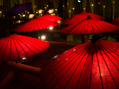 six red japanese umbrellas at nighttime thumbnail