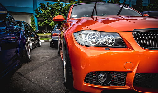 orange BMW vehicle parked during daytime thumbnail