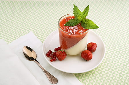 clear drinking glass filled with red and white liquid on white plate thumbnail