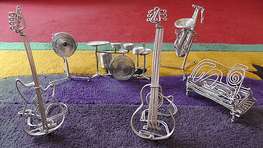gray steel musical instrument mini figure on purple rug thumbnail