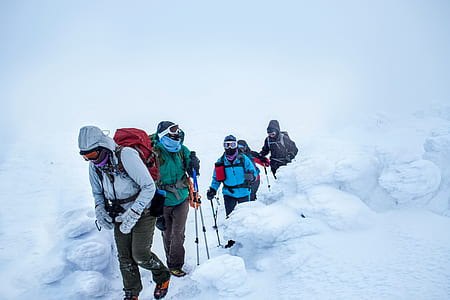 several people hiking on mountain covered with snoew thumbnail