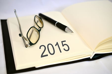 2015 text on white book page beside eyeglasses and pen thumbnail
