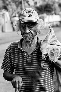 Grayscale Photography Of Man Wearing Polo Shirt And Holding Sack thumbnail