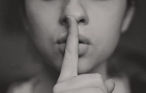 grayscale photo of woman with quiet gesture thumbnail