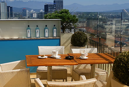 two brown wooden patio tables with chairs thumbnail