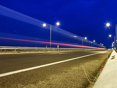 time-lapse photography of red lights on asphalt road thumbnail