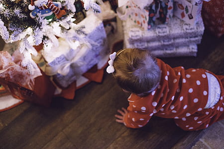 photo of toddler crawling towards Christmas gift boxes thumbnail