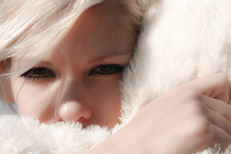 woman head on white fur pillow thumbnail