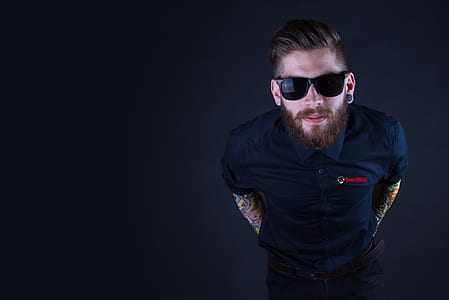 man wearing black framed sunglasses and black button-up shirt thumbnail