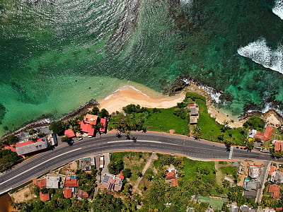 aerial photography of residential beside body of water during daytime thumbnail