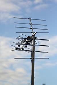 grey outdoor antenna under blue and white sky thumbnail