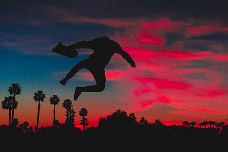 silhouette of man making tricks on his skateboard thumbnail