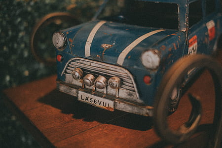 blue and gray die-cast metal car toy on brown wooden surface thumbnail