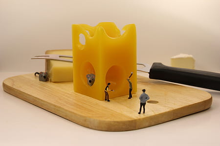 working people figurines on chopping board with cheese thumbnail
