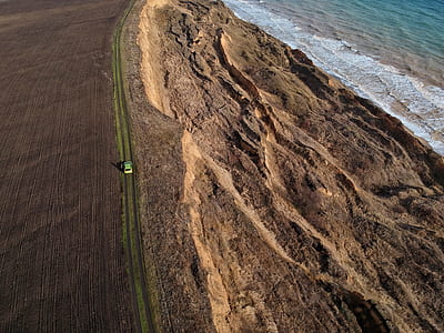 aerial photography of car near sea thumbnail