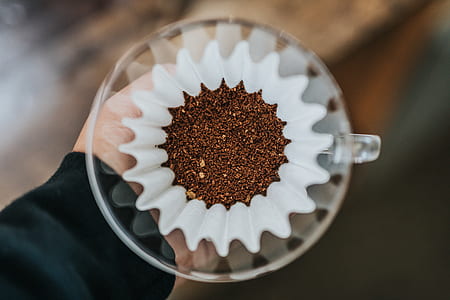 ground coffee on white strainer thumbnail