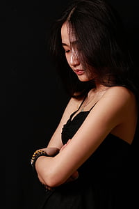 brown haired woman wearing black spaghetti strap top thumbnail