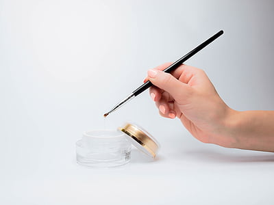 person's hand holding brush thumbnail
