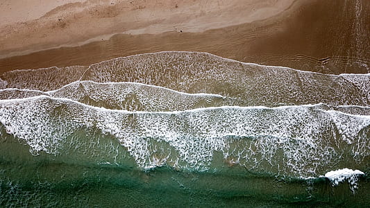aerial photography of ocean waves hitting seashores thumbnail