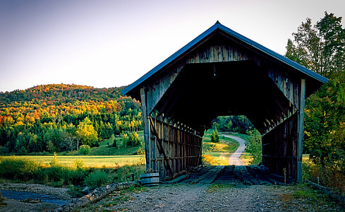 brown wooden tunnel house under gray sky during daytime thumbnail
