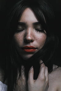 woman closing eyes with red lipstick holding her black hair photography thumbnail