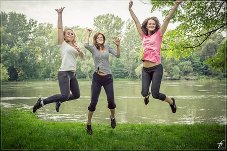 three women jumping at lake side thumbnail