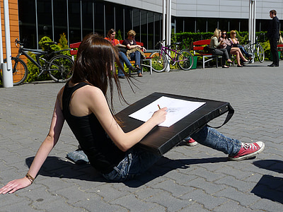 woman sitting on gray pavement during daytime thumbnail