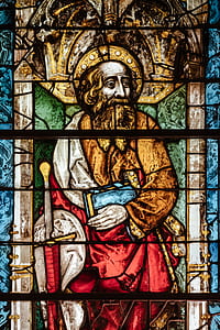 man holding blue book stained glass thumbnail