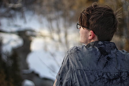selective focus photography of man facing trees thumbnail