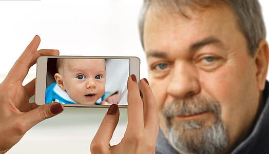 person holding phone taking photo thumbnail