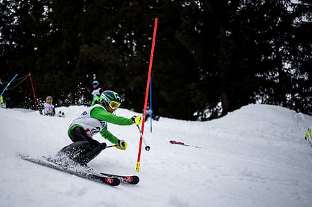man skiing holding ski pole thumbnail