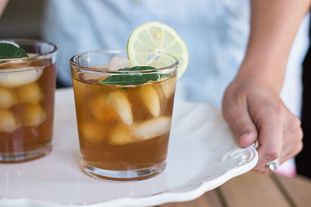 selective focus photography of iced teal with lemon served on white ceramic plate thumbnail