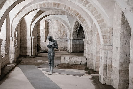 black concrete statue on gray hallway thumbnail
