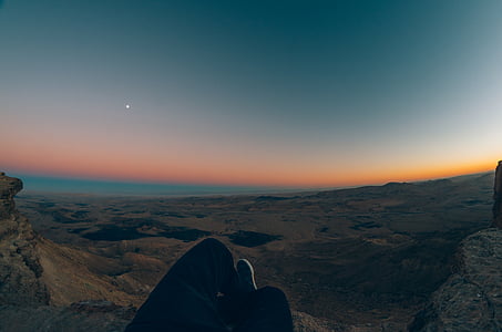 person lying on the mountain edge thumbnail