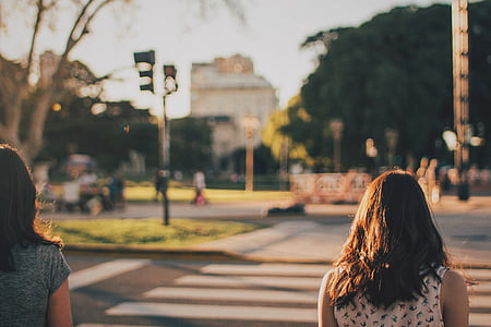 two woman walks on pedestrian lane thumbnail