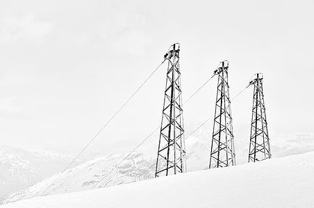 three utility towers in snow landscape thumbnail