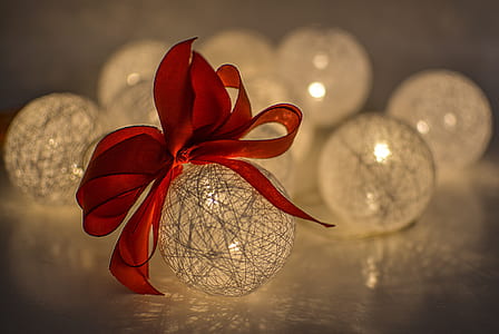macro photography of yarn lamp with red ribbon thumbnail