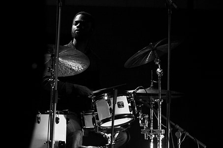 man playing drums grayscale photo thumbnail