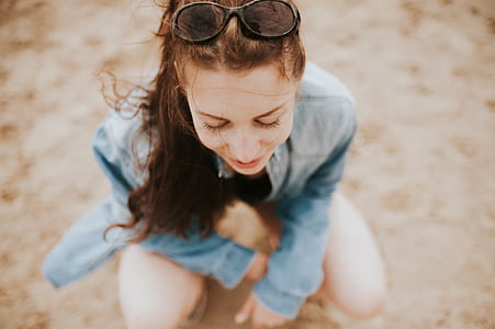 woman in blue long-sleeved shirt with black sunglasses thumbnail