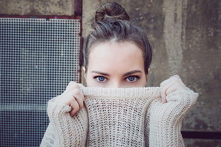 shallow focus photography of woman wearing gray sweater thumbnail