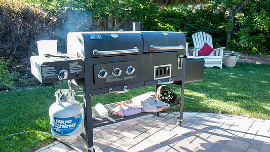 black outdoor gas grill on gray pavement thumbnail