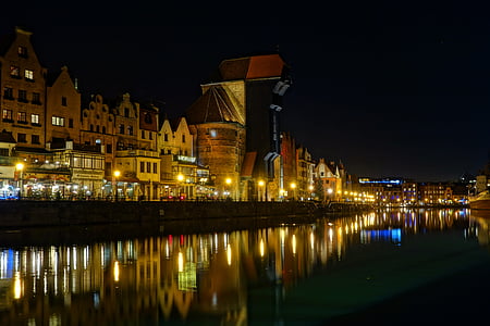 city beside body of water during nighttime thumbnail