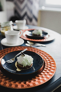 Sweet little white chocolate dessert on a blue saucer in a cake shop thumbnail