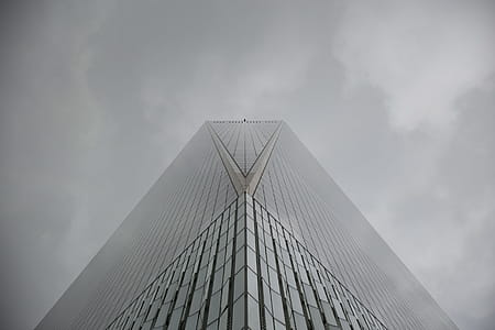 Corner view of a glass skyscraper on a cloudy day thumbnail