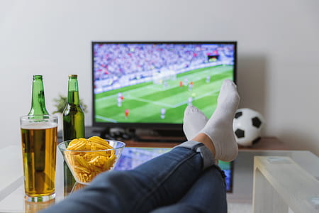 Watching a soccer match on TV with the feet on the table. thumbnail