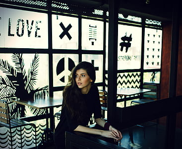 woman sitting on cafe near to glass window thumbnail