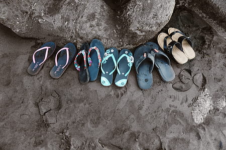 Assorted Flip-flops on Sand thumbnail