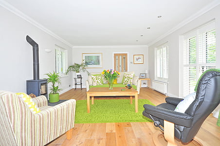 person in front of flower arrangement on top of coffee table thumbnail