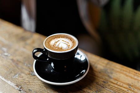 black and white liquid on black ceramic mug and saucer thumbnail
