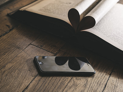 space gray iPhone 6 on brown wooden table thumbnail